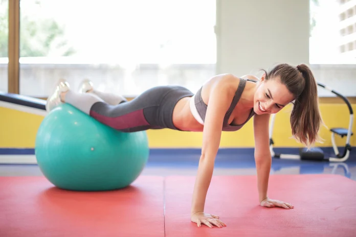 Woman doing a fitness workout with an exercise ball