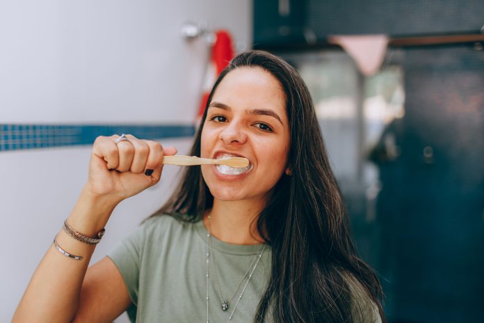 Woman brushing her teeth for better oral health