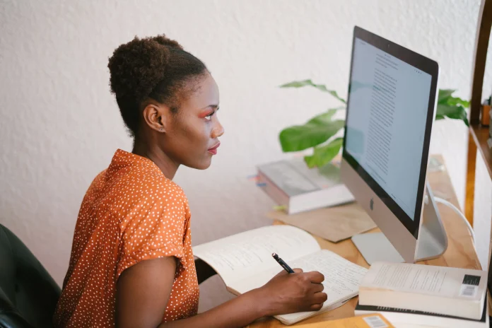 Woman sitting at a desk and working on a computer